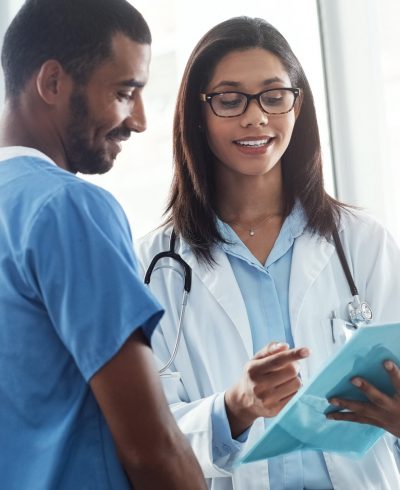 Medical teamwork at its best. two young doctors discussing the contents of a file in a modern hospital